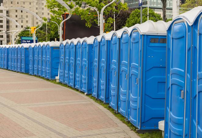 a line of portable restrooms at a sporting event, providing athletes and spectators with clean and accessible facilities in Algonac MI